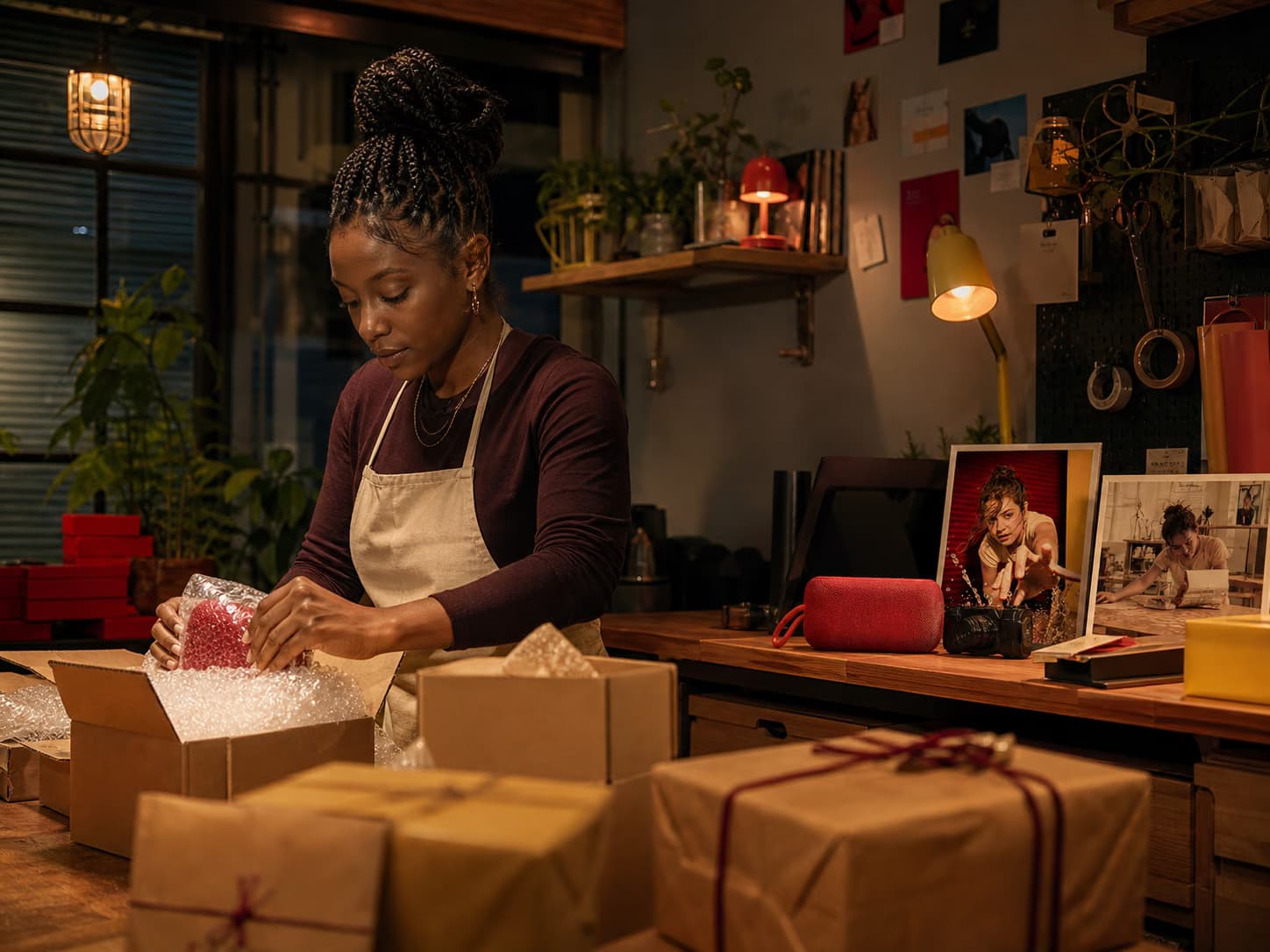 A small-business creator packing orders on camera