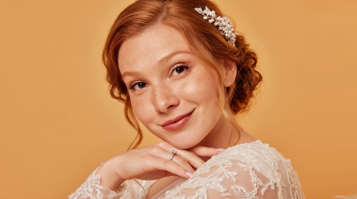 Young girl with red hair, a floral headband, and a white lace dress" "Girl in an Egyptian-inspired costume lying on grass" "Woman with dark hair covering her face with her hand, with a small heart on her cheek"