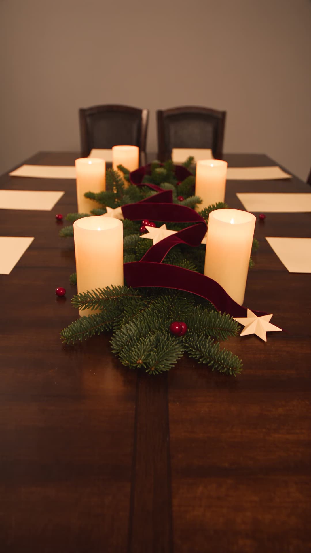 Modern candlelit Christmas table ready for guests.