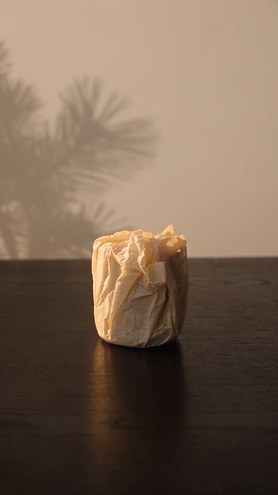 Handcrafted ceramic candle unwrapped in warm light.