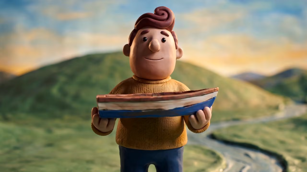 Figura od plastelina drži poslužavnik na zelenom obronku, iz stop-motion filma napravljenog u Picsart Flow