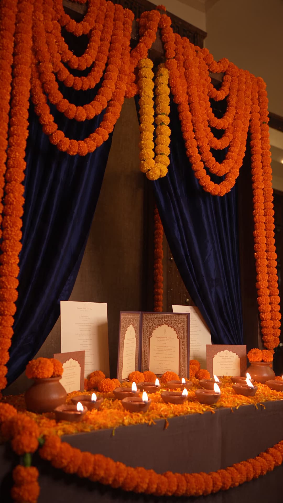 Marigold, indigo, cream cards, and safely placed diyas.