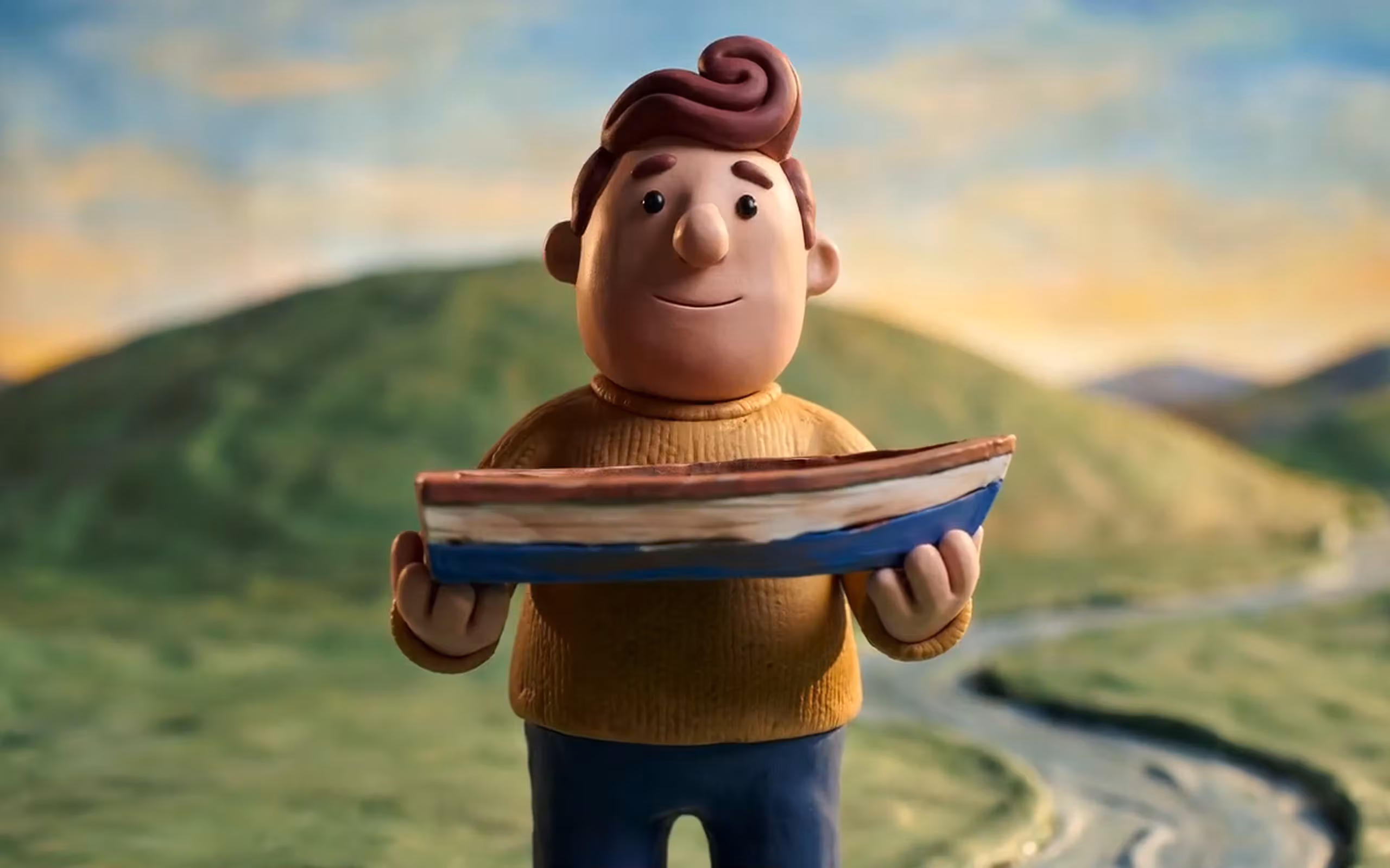 A clay figure holding a tray on a green hillside, from a stop-motion film made in Picsart Flow