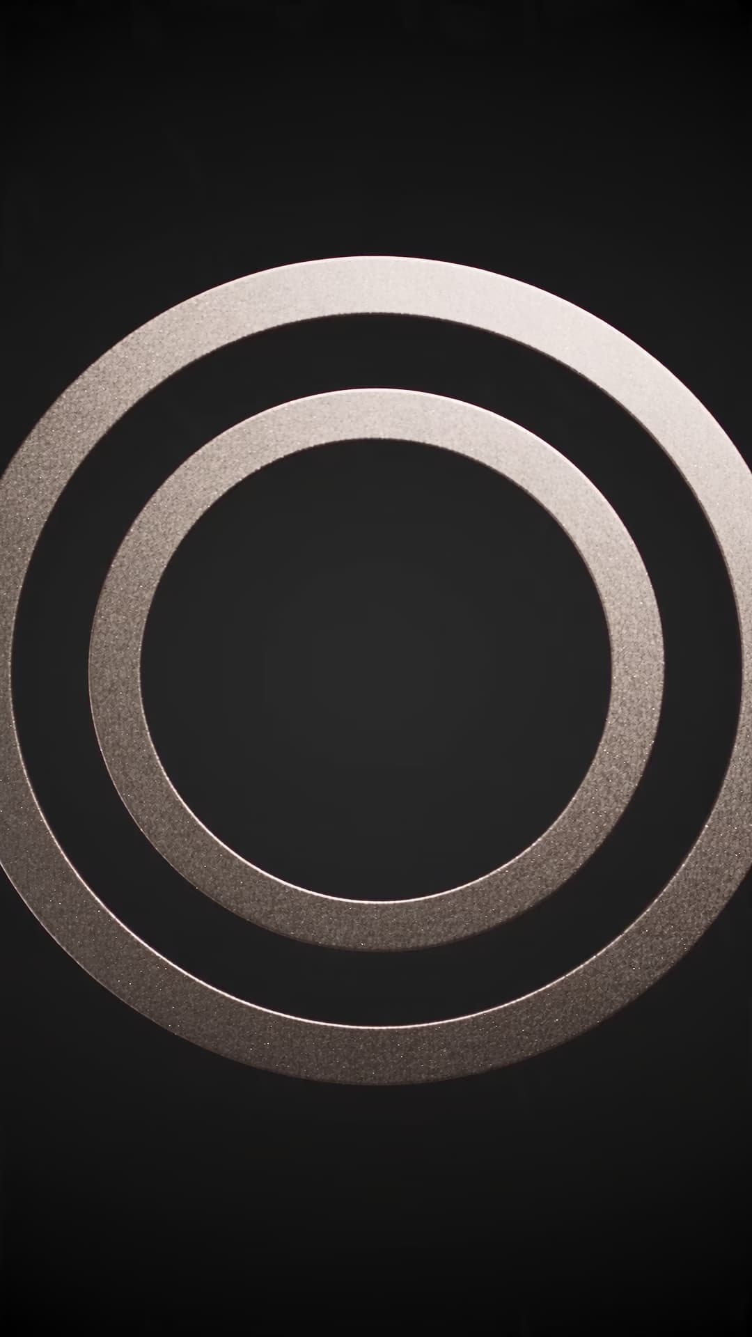 Metallic paper rings closing toward a glowing center.